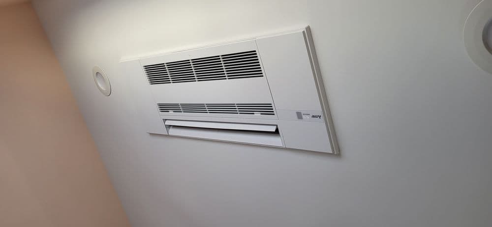 Wall-mounted air conditioning unit in a minimalist room setting. Energy-efficient cooling solution.